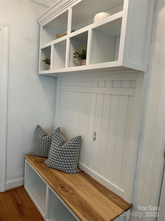 mudroom with baseboards and wood finished floors