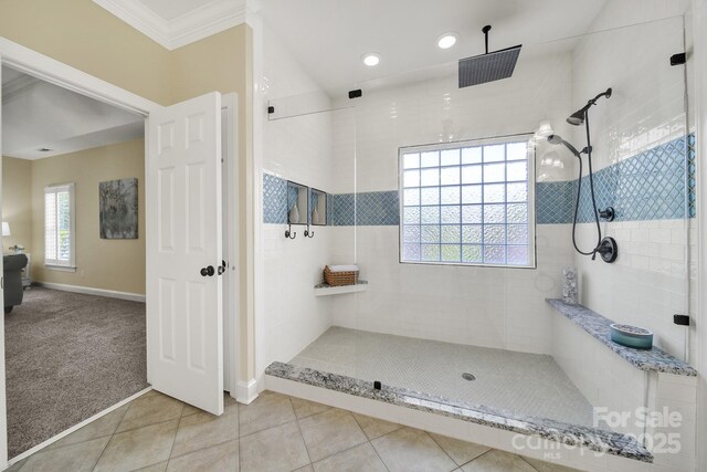 bathroom featuring crown molding, tile patterned floors, baseboards, recessed lighting, and tiled shower