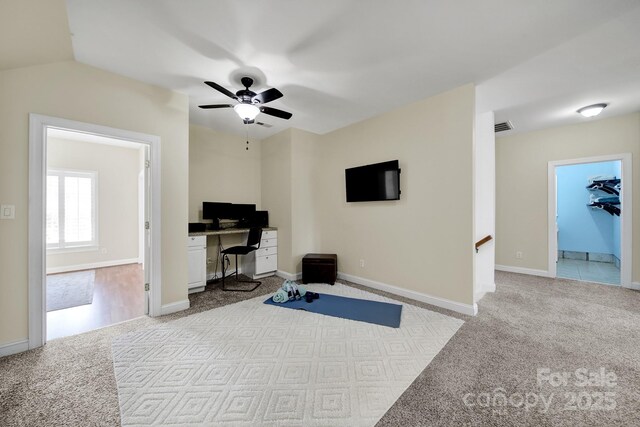 workout room with a ceiling fan, baseboards, visible vents, and carpet