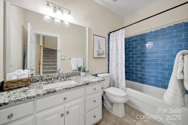 full bath with vanity, tile patterned flooring, toilet, and shower / tub combo with curtain