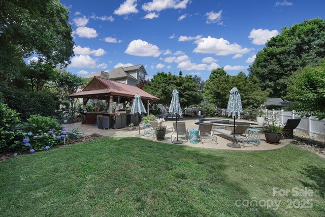 view of yard with a gazebo, a patio area, fence, and a jacuzzi