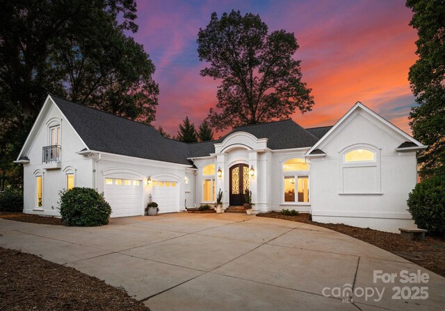 102 Stone Point Ct, Mooresville, NC 28117 - view of front of house featuring french doors, a shingled roof, stucco siding, and concrete driveway