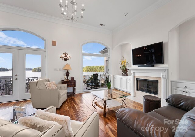 102 Stone Point Ct, Mooresville, NC 28117 - living room with crown molding, french doors, hardwood / wood-style floors, and a fireplace