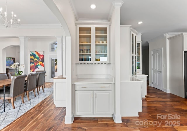 102 Stone Point Ct, Mooresville, NC 28117 - corridor with dark wood-type flooring, arched walkways, and ornamental molding