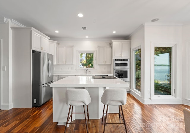 102 Stone Point Ct, Mooresville, NC 28117 - kitchen with a breakfast bar, light countertops, a center island, stainless steel appliances, and a sink