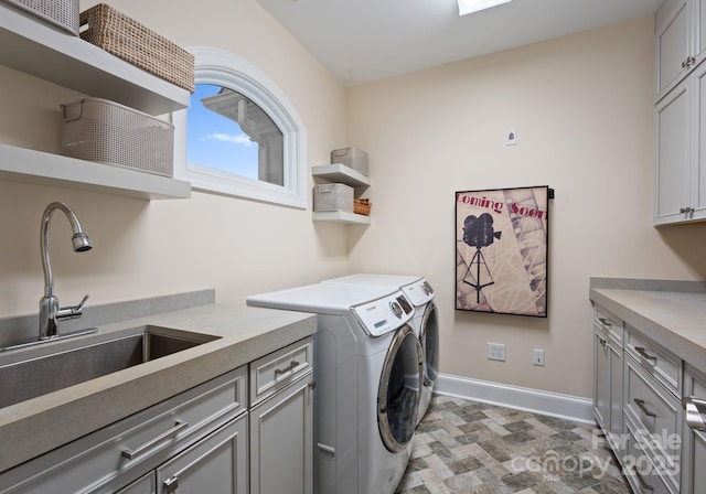 102 Stone Point Ct, Mooresville, NC 28117 - laundry room with baseboards, separate washer and dryer, a sink, and cabinet space