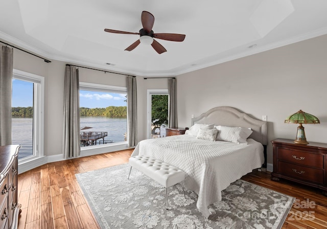 102 Stone Point Ct, Mooresville, NC 28117 - bedroom featuring crown molding, access to outside, a raised ceiling, and light wood-style floors