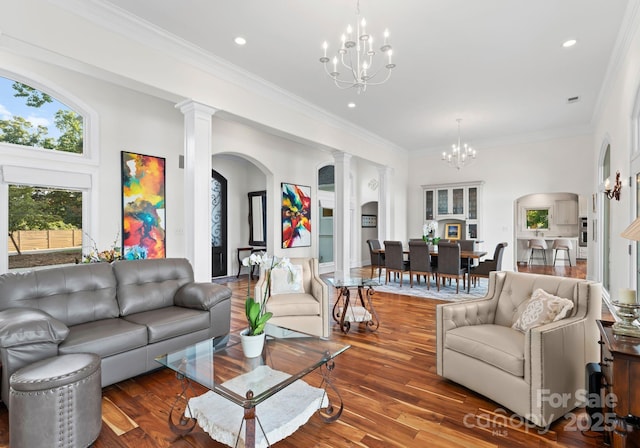 102 Stone Point Ct, Mooresville, NC 28117 - living room with ornamental molding, a chandelier, ornate columns, arched walkways, and wood finished floors