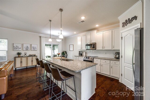 317 Praline Way, Fort Mill, SC 29715 - kitchen with visible vents, a sink, stainless steel appliances, white cabinets, and crown molding