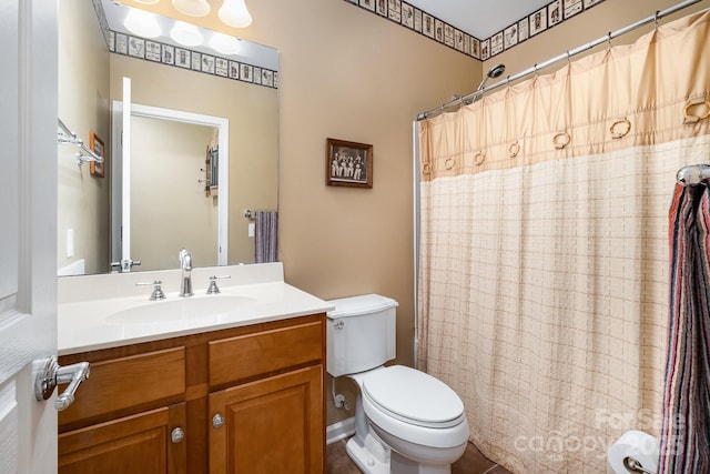 bathroom with toilet, vanity, and a shower with curtain