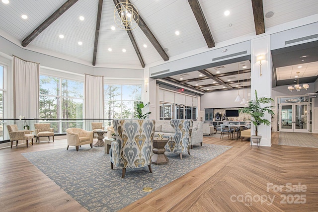 living room featuring beamed ceiling, high vaulted ceiling, and a chandelier