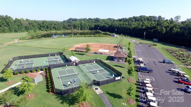drone / aerial view featuring a water view and a forest view