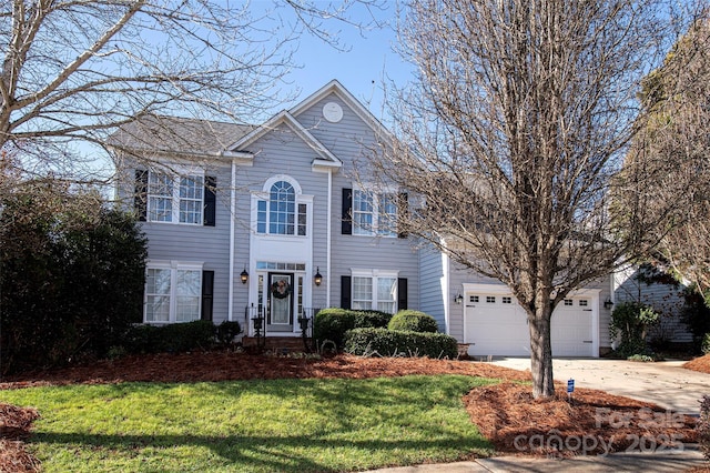 colonial house featuring a garage, a front yard, and driveway