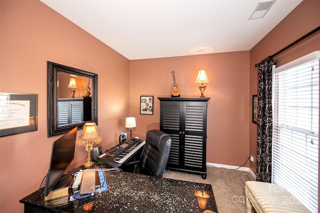 carpeted office space featuring baseboards and visible vents
