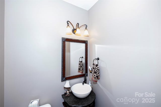 half bathroom featuring a sink