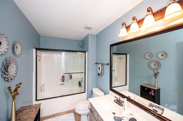 full bathroom with visible vents, bath / shower combo with glass door, toilet, and vanity