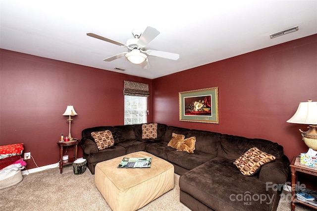 living room featuring visible vents, baseboards, a ceiling fan, and carpet floors