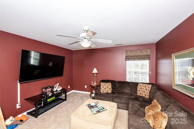 carpeted living room with visible vents, baseboards, and a ceiling fan