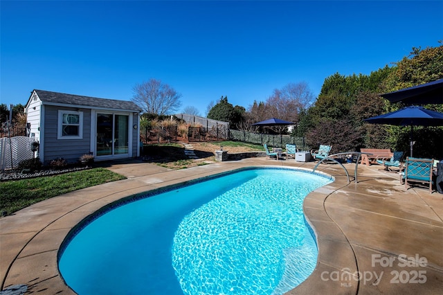 view of pool with a fenced in pool, a storage structure, an outdoor structure, a fenced backyard, and a patio