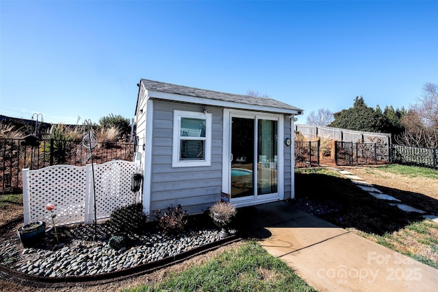 view of outbuilding with an outbuilding and fence