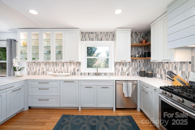 36 Brookcliff Dr, Asheville, NC 28804 - kitchen featuring a sink, open shelves, backsplash, white cabinetry, and stainless steel appliances