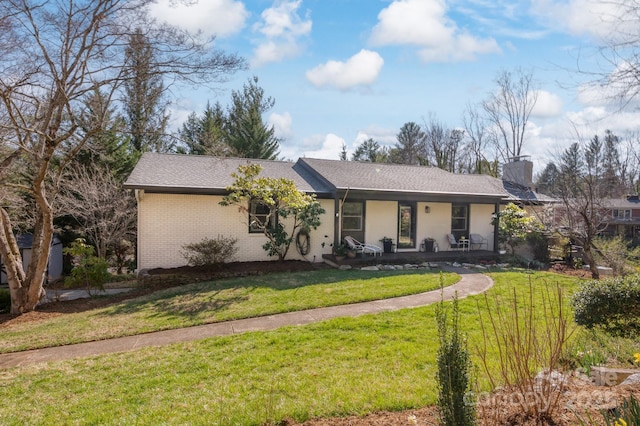 36 Brookcliff Dr, Asheville, NC 28804 - view of front of home with brick siding, a shingled roof, a front yard, covered porch, and a chimney