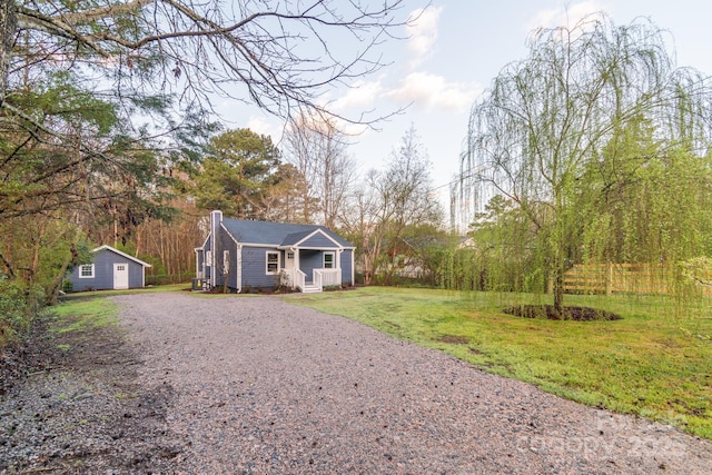6282 Richburg Rd, Great Falls, SC 29055 - view of front facade featuring a front lawn, an outbuilding, gravel driveway, and a chimney
