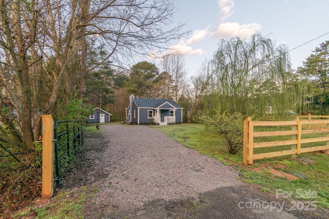 6282 Richburg Rd, Great Falls, SC 29055 - view of front of property featuring an outbuilding, fence, gravel driveway, a front yard, and a chimney