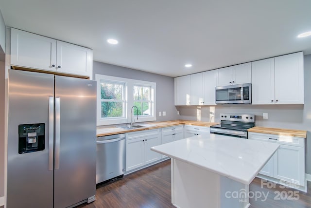 6282 Richburg Rd, Great Falls, SC 29055 - kitchen featuring dark wood-type flooring, a sink, wood counters, white cabinetry, and appliances with stainless steel finishes