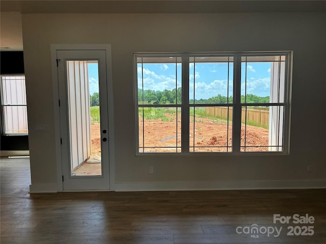 1370 Coppergate Dr, Salisbury, NC 28147 - empty room with dark wood-type flooring, healthy amount of natural light, and baseboards