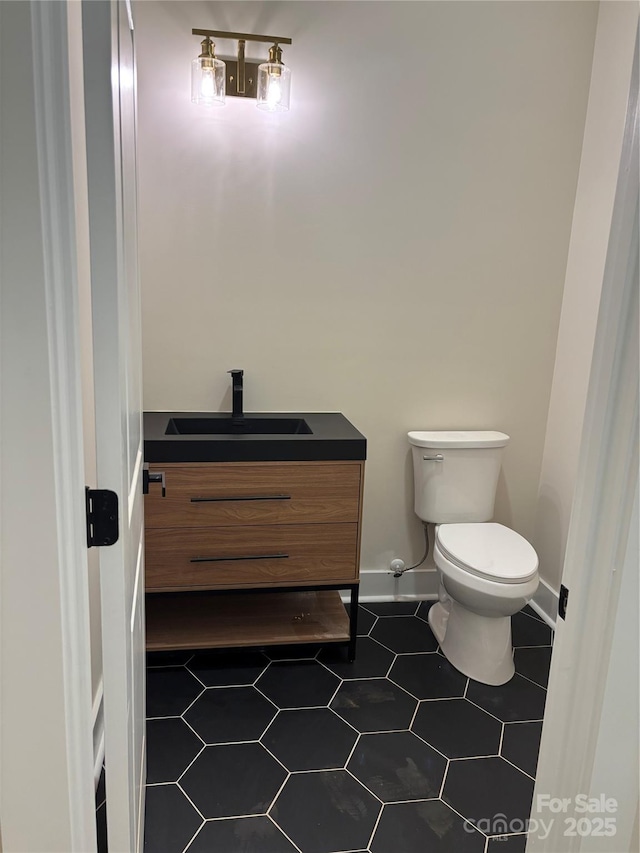 1370 Coppergate Dr, Salisbury, NC 28147 - bathroom with toilet, vanity, and baseboards