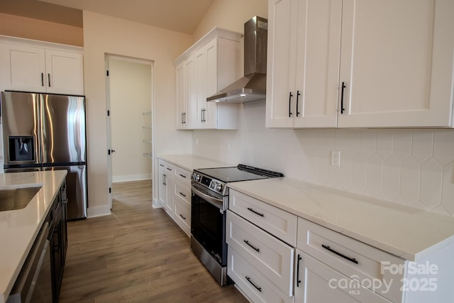 1370 Coppergate Dr, Salisbury, NC 28147 - kitchen featuring wall chimney range hood, appliances with stainless steel finishes, white cabinetry, dark wood-style flooring, and tasteful backsplash