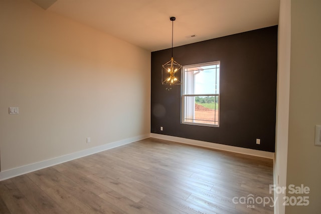 1370 Coppergate Dr, Salisbury, NC 28147 - spare room featuring wood finished floors and a chandelier