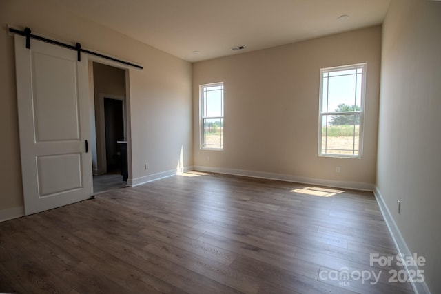 1370 Coppergate Dr, Salisbury, NC 28147 - unfurnished bedroom with a barn door and wood finished floors