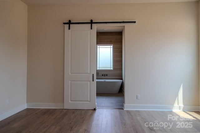 1370 Coppergate Dr, Salisbury, NC 28147 - unfurnished room with wood finished floors and a barn door