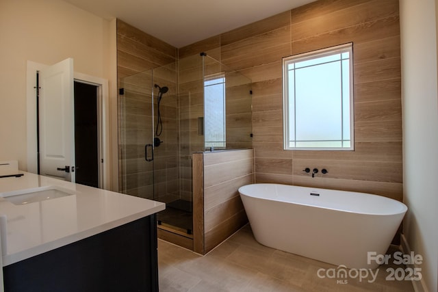 1370 Coppergate Dr, Salisbury, NC 28147 - full bath featuring a shower stall, vanity, a soaking tub, plenty of natural light, and tile walls