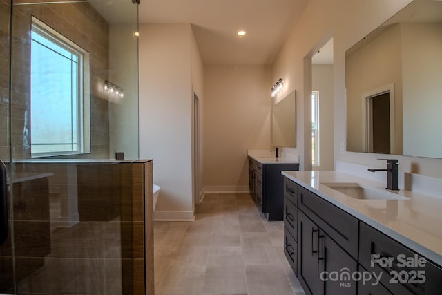 1370 Coppergate Dr, Salisbury, NC 28147 - bathroom with two vanities, a soaking tub, a tile shower, and recessed lighting