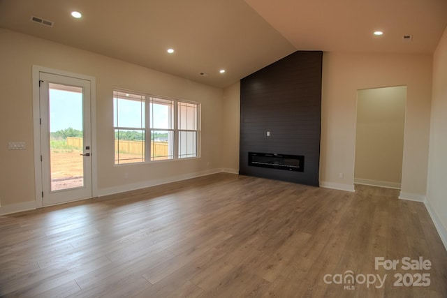 1370 Coppergate Dr, Salisbury, NC 28147 - unfurnished living room with vaulted ceiling, wood finished floors, a large fireplace, and recessed lighting