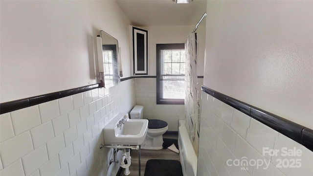 11 Season Ln, Asheville, NC 28805 - bathroom featuring tile walls, a wainscoted wall, shower / washtub combination, and wood finished floors