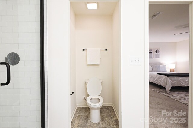 13024 Suncreek Ter, Charlotte, NC 28214 - bathroom with toilet, connected bathroom, baseboards, visible vents, and tiled shower