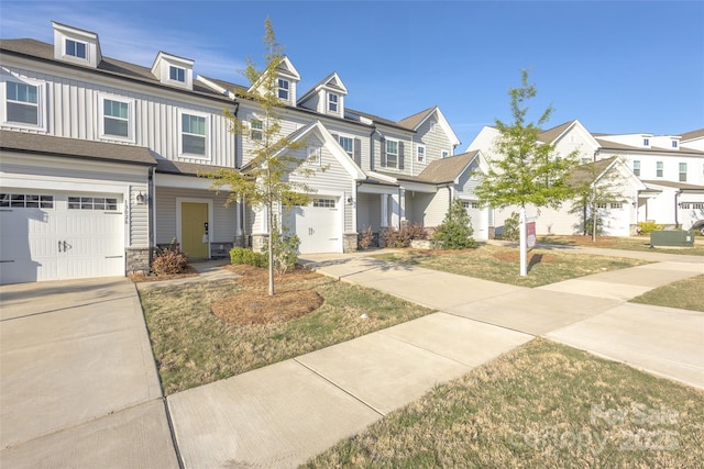 13024 Suncreek Ter, Charlotte, NC 28214 - townhome / multi-family property featuring board and batten siding, an attached garage, stone siding, and driveway