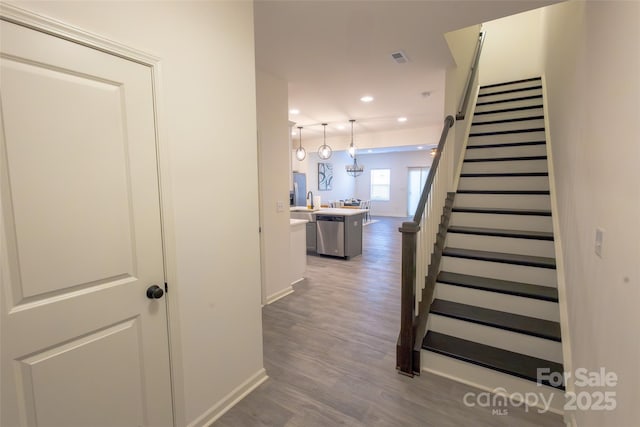 13024 Suncreek Ter, Charlotte, NC 28214 - hallway featuring wood finished floors, baseboards, recessed lighting, and stairway
