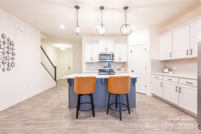 13024 Suncreek Ter, Charlotte, NC 28214 - kitchen with appliances with stainless steel finishes, tasteful backsplash, white cabinetry, and light countertops