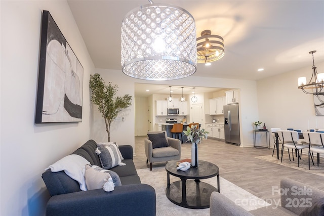 13024 Suncreek Ter, Charlotte, NC 28214 - living area featuring light wood-style flooring and a notable chandelier