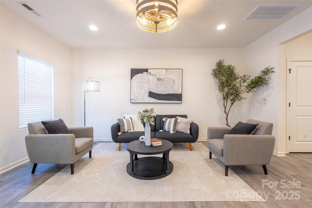 13024 Suncreek Ter, Charlotte, NC 28214 - living area featuring baseboards, wood finished floors, and visible vents