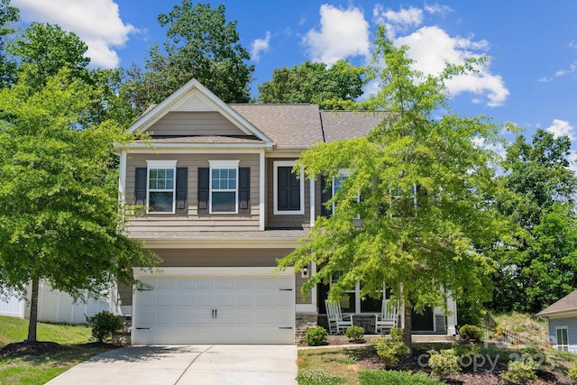 117 Cramerton Mills Parkway, Cramerton, NC 28032 - craftsman-style house featuring a garage, covered porch, stone siding, roof with shingles, and concrete driveway