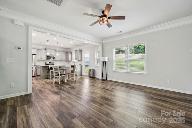 117 Cramerton Mills Parkway, Cramerton, NC 28032 - living room with visible vents, ornamental molding, ceiling fan, and dark wood-style floors