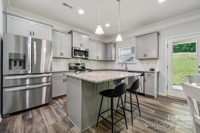 117 Cramerton Mills Parkway, Cramerton, NC 28032 - kitchen with stainless steel appliances, gray cabinets, dark wood finished floors, a sink, and ornamental molding