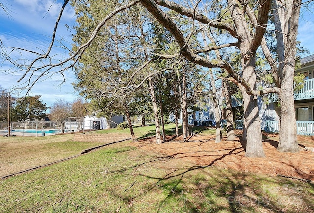 view of yard featuring a fenced in pool and fence