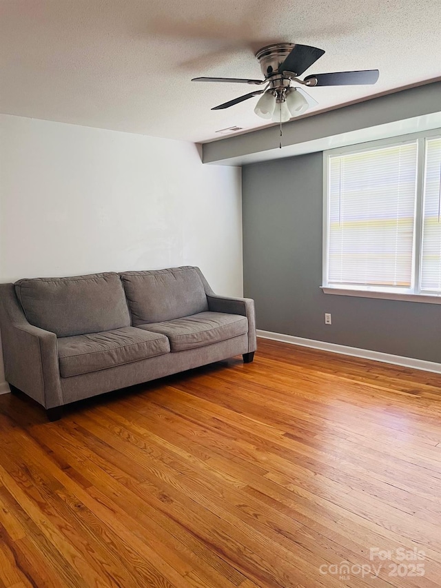 3232 Wilson Heights Dr, Hildebran, NC 28637 - living room featuring ceiling fan, light wood finished floors, and a textured ceiling